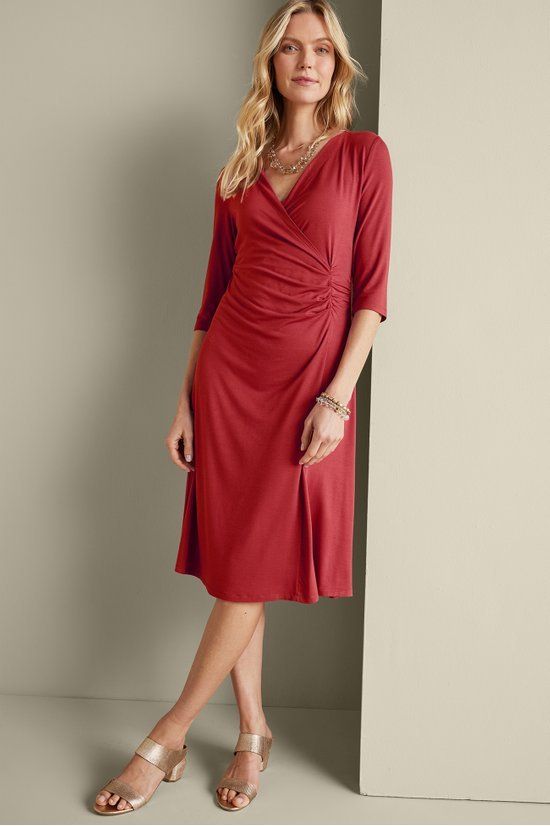 The beloved wrap dress has always been a style icon and this faux wrap design has long been a Soft favorite, now in a shorter length. Shirring detail at waist creates the perfect hourglass figure. Elbow-length sleeves. Elegant V-neck Dress With Surplice Neckline For Fall, Chic Ruched Wrap Dress For Fall, Fall Fitted Wrap Dress With Surplice Neckline, Fall Dresses With Faux Wrap And Surplice Neckline, Fall Dress With Faux Wrap And Surplice Neckline, Ruched Surplice Neckline Midi Dress For Work, Ruched Midi Dress With Surplice Neckline For Work, Formal Knee-length Faux Wrap Dress, Ruched V-neck Wrap Dress For Formal Occasions