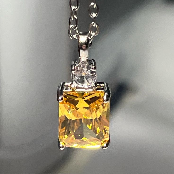 Silver Plated Citrine Pendant In 4 Prong Setting With Simulated Diamond. Gorgeous And Very Sparkly! Pendant: 0.5” X 0.25” Necklace: 18” Elegant Yellow Rectangular Necklaces, Elegant Yellow Rectangular Necklace, Classic Yellow Pendant Necklace, Classic Yellow Jewelry As Gift, Yellow Cubic Zirconia Necklace As A Gift, Yellow Cubic Zirconia Necklace For Gift, Yellow Cubic Zirconia Necklaces For Gifts, Classic Yellow Pendant Jewelry, Yellow Pendant Necklace Nickel Free