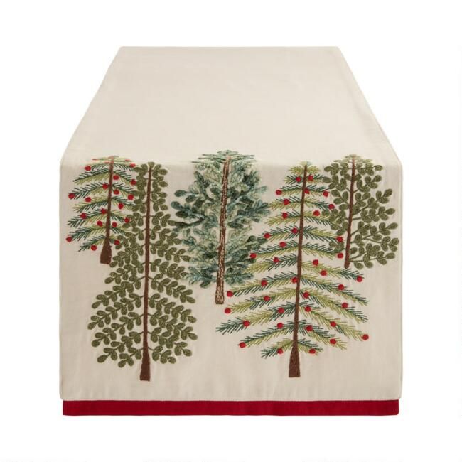 a table runner with trees and berries on it