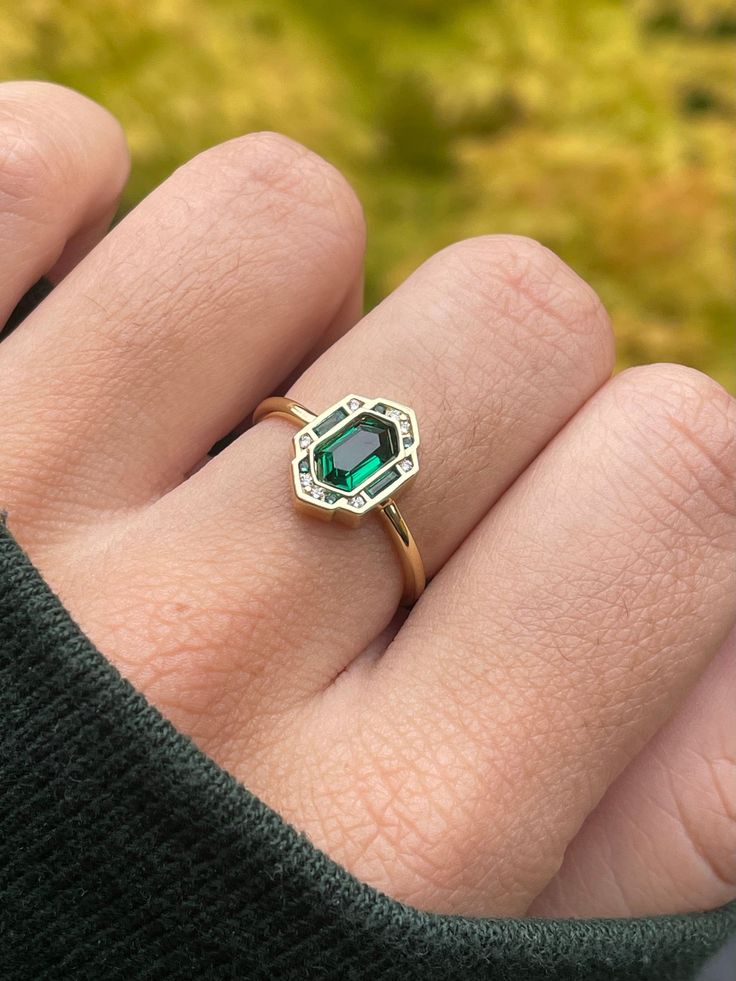 Our Oz Ring brings us straight to the Emerald City. Geometric, dazzling, and full of personality, the Oz Ring is the perfect piece to start your jewelry collection. * * * Don't know your ring size? View our Ring Size Guide * * * …………………………………. RING SIZE & MATERIAL❋ 18k gold plated sterling silver or sterling silver❋ cubic zirconia crystals❋ nickel free May Birthstone Diamond Ring In Art Deco Style, Art Deco Diamond Ring With May Birthstone, May Birthstone Art Deco Diamond Ring, Modern Emerald Rings With Center Stone, Emerald Open Ring With Center Stone, Emerald Cut Promise Rings Fine Jewelry, Fine Jewelry May Birthstone Octagon Rings, Open Emerald Ring With Accent Stones, Emerald Open Ring With Accent Stones