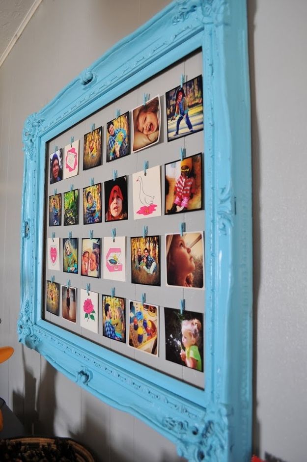 a blue frame filled with pictures hanging on the wall