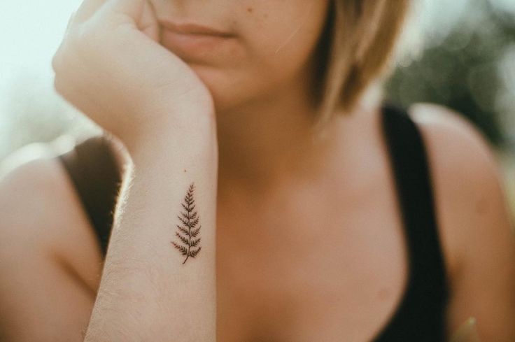 a woman with a small tattoo on her arm