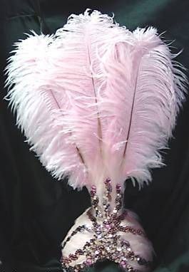 a pink feather headdress on a black background