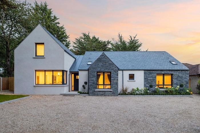 a house that is sitting in the gravel