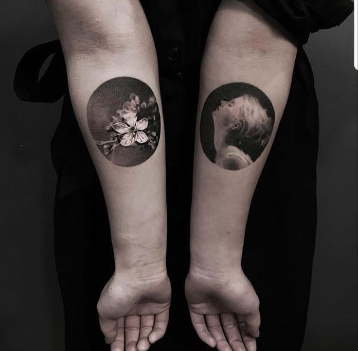 two people with matching tattoos on their arms