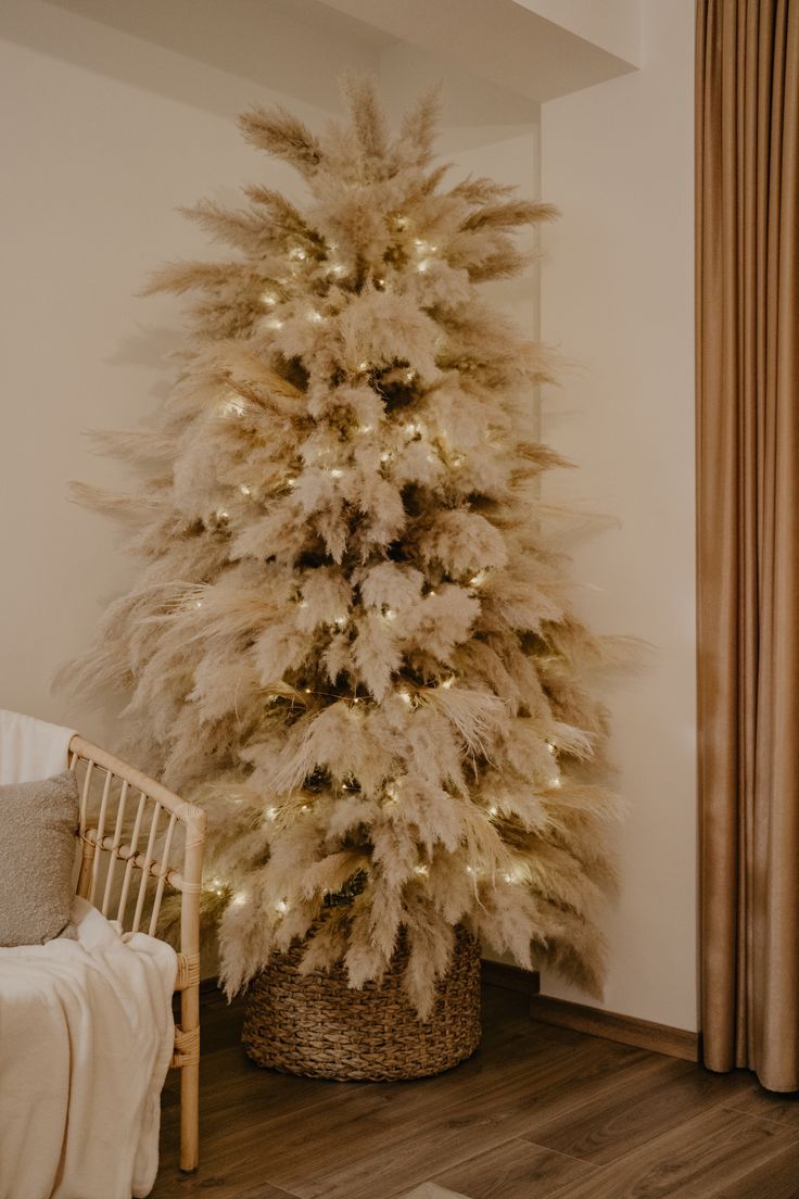 a white christmas tree with lights in a room