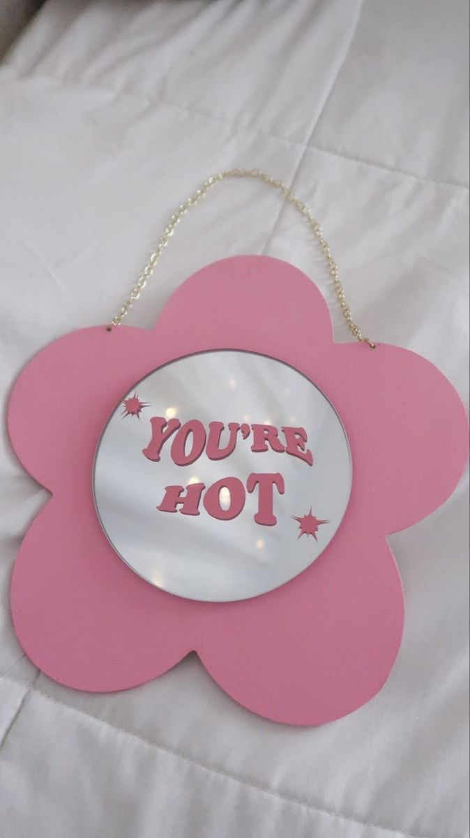 a pink flower shaped sign that says you're hot with stars on the bottom