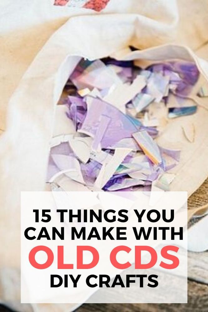 an old cd bag filled with cds and other crafting supplies on top of a wooden table