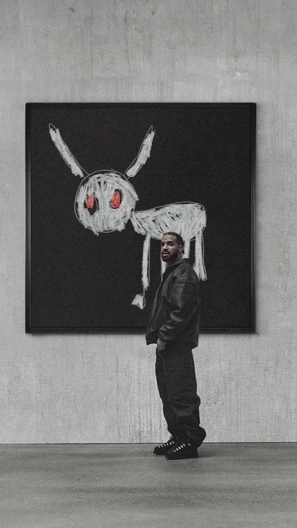 a man standing in front of a painting with a spider on it's back