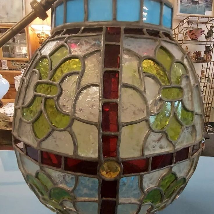 a stained glass lamp sitting on top of a table