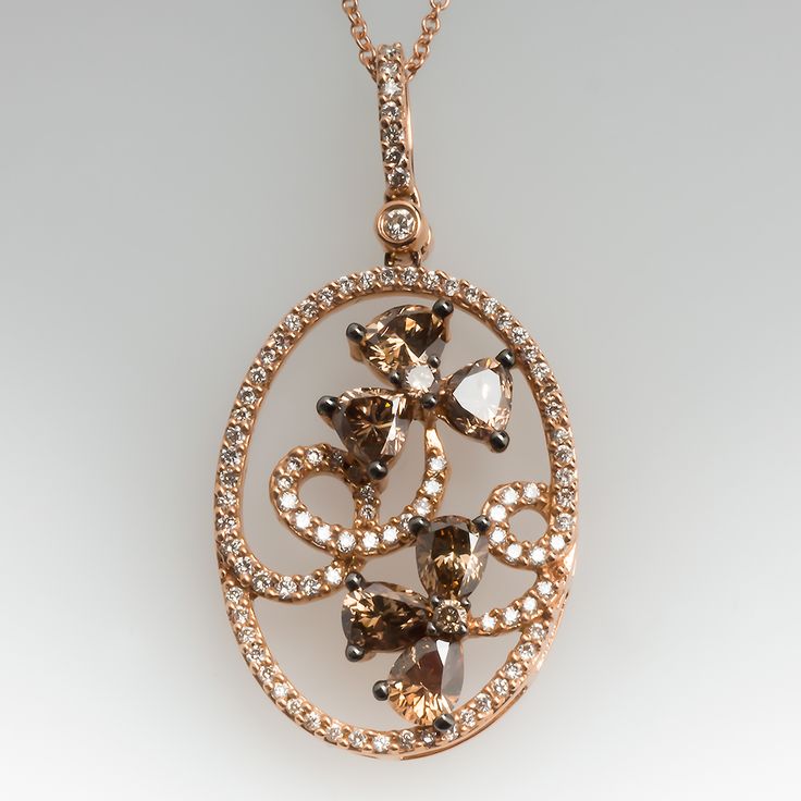 This gorgeous Carlo Viani necklace is crafted of 14k rose gold and features a floral diamond motif. The pendant is set with 6 fancy brown pear cut diamonds, 2 fancy brown round brilliant diamonds, and 94 smaller round brilliant accent diamonds. The total diamond weight is 1.89 carats. The pendant is in excellent condition and hangs from a 14k rose gold 18-inch chain. Ask us about a matching Carlo Viani ring. Luxury Brown Jewelry With Brilliant Cut, Luxury Brown Jewelry With Diamond Accents, Elegant Brown Oval Jewelry, Elegant Oval Brown Jewelry, Elegant Brown Oval Pendant Necklace, Elegant Brown Pendant Jewelry, Elegant Brown Necklace For Anniversary, Floral Pendant Necklace, Pear Cut Diamond