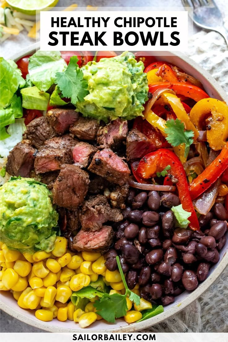 a bowl filled with steak, beans and veggies on top of a table