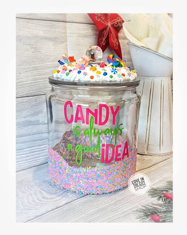 a glass jar filled with candy and sprinkles