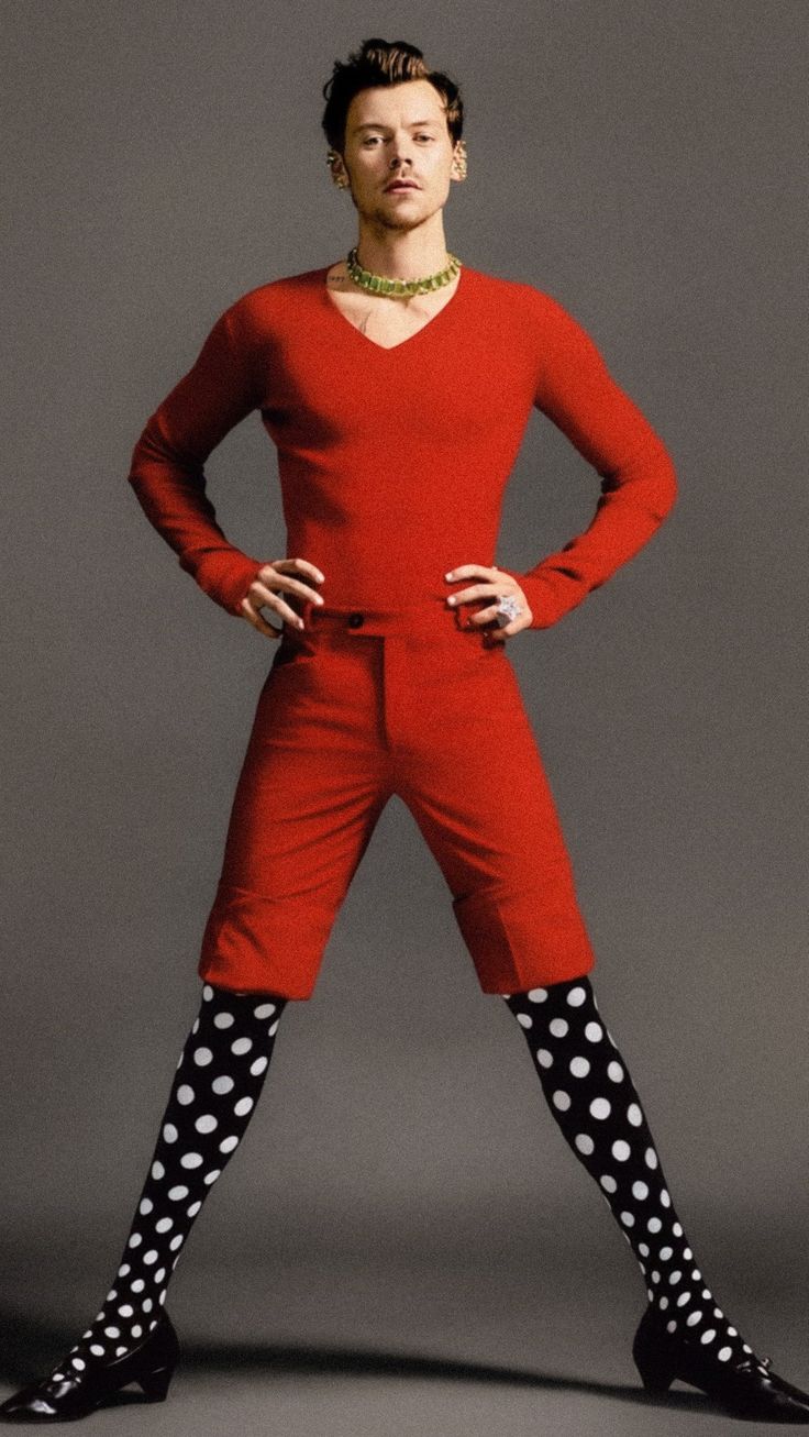 a woman in red is posing with her hands on her hips and wearing polka dot socks