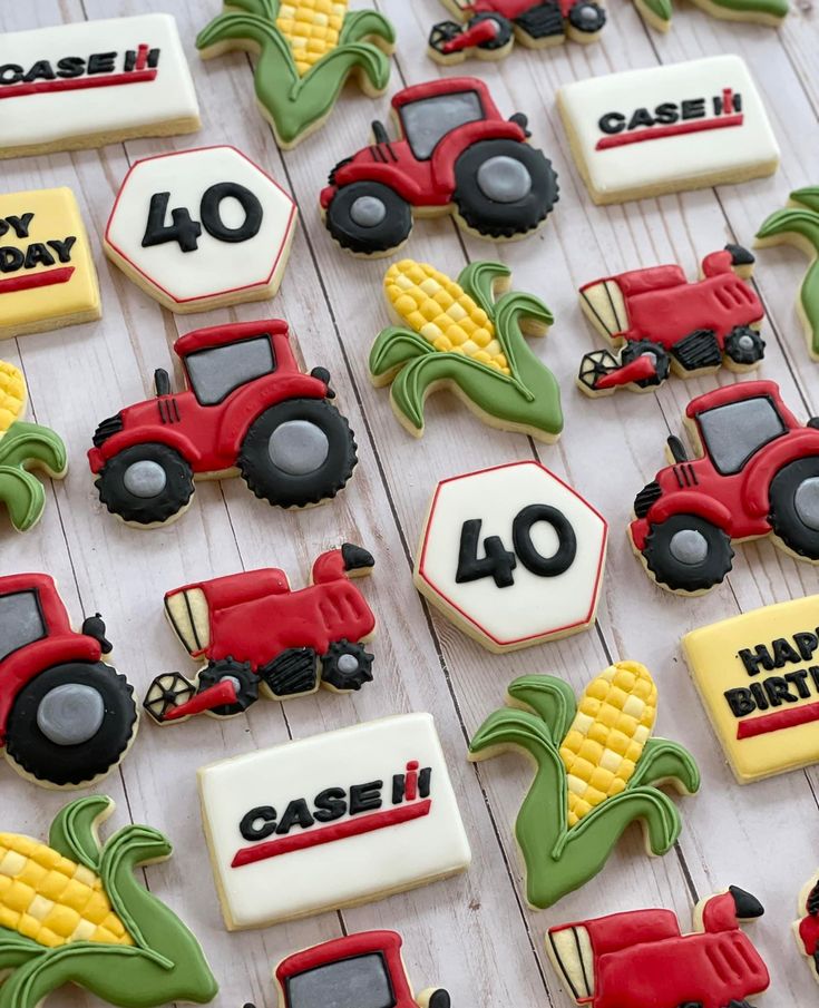 decorated cookies with tractors and farm vehicles are on a white wooden table, along with happy birthday messages