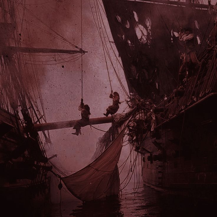 two men are sitting on the end of a sailboat in an old time photo