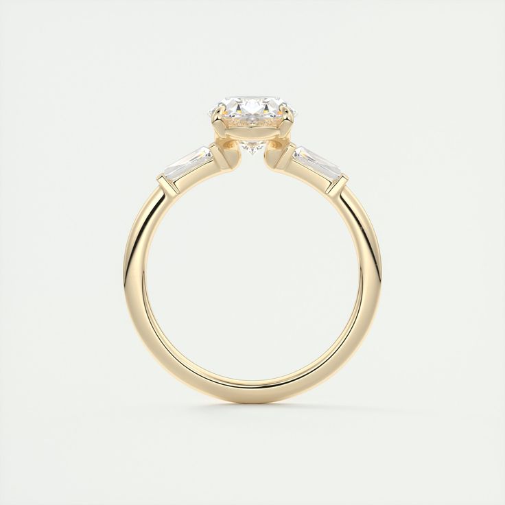 a yellow gold engagement ring with three stones