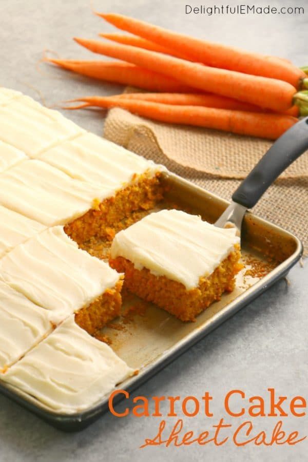 carrot cake with white frosting in a pan and carrots next to the tray