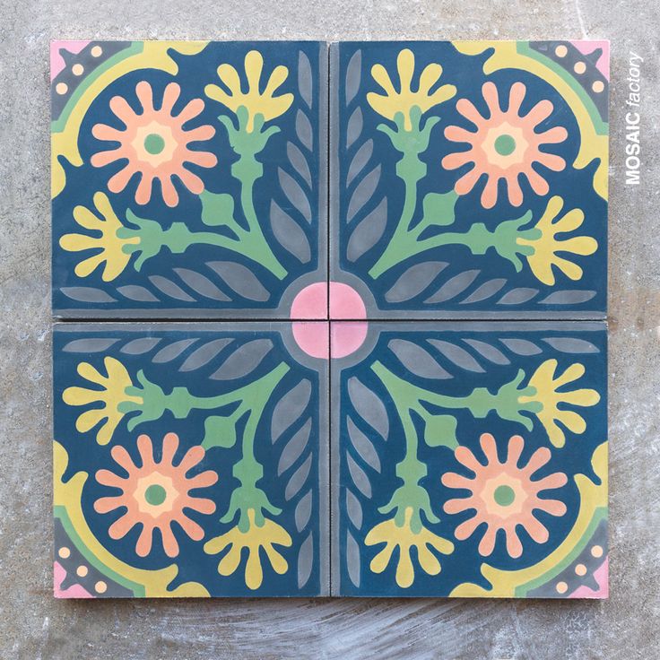 three tiles with flowers painted on them sitting on top of a cement floor next to each other