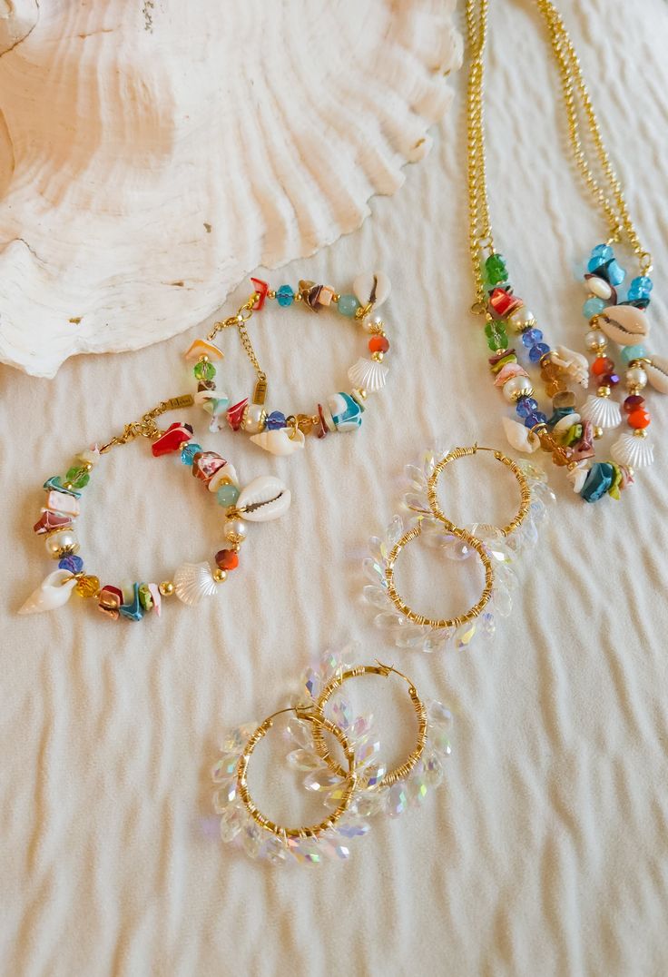 Embrace your inner beach babe with this unique bracelet. Featuring an eye-catching colorful beads design, steel beads, glass beads, and real sea shells, it's the ultimate must-have for all your seaside adventures. Add some beachy vibes to your style with this playful and one-of-a-kind bracelet! Beach Season Tiny Beads Bracelets, Beaded Shell Strand Bracelets, Shell Bracelet For Beach, Shell Bracelet Jewelry For Beach, Ocean-inspired Beaded Bracelets For Beach, Tiny Beads Bracelets For Beach Season Gift, Colorful Beaded Jewelry For Vacation, Bohemian Beaded Chain Bracelets For Beach, Bohemian Beaded Bracelets For Vacation