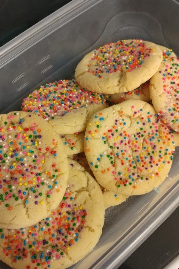 several cookies with sprinkles in a plastic container