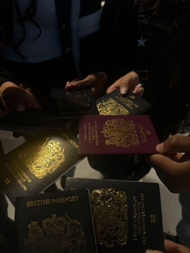 several people holding british passports in their hands