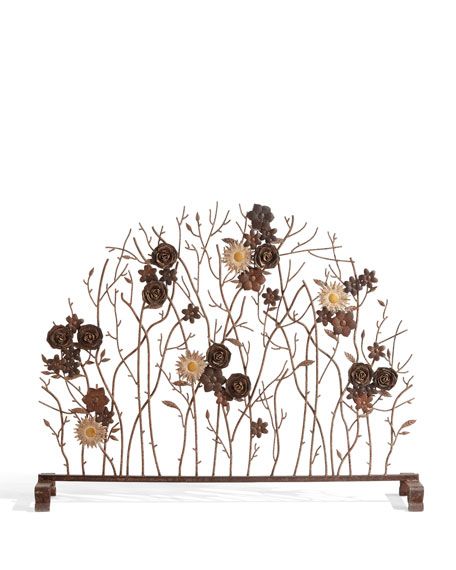 a metal sculpture with flowers and branches on it's sides, against a white background