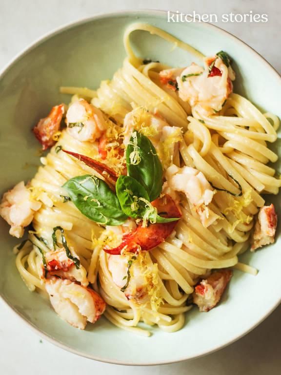 a white bowl filled with pasta and shrimp