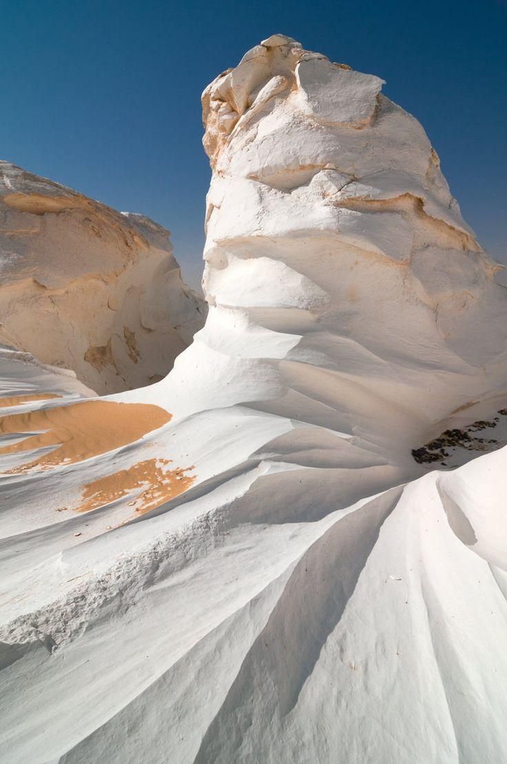 a snow covered mountain is shown against a blue sky