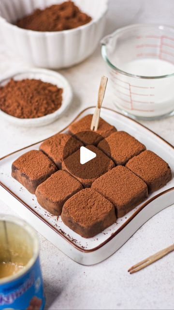 there is a cake that has been cut into squares and placed on a plate with spoons