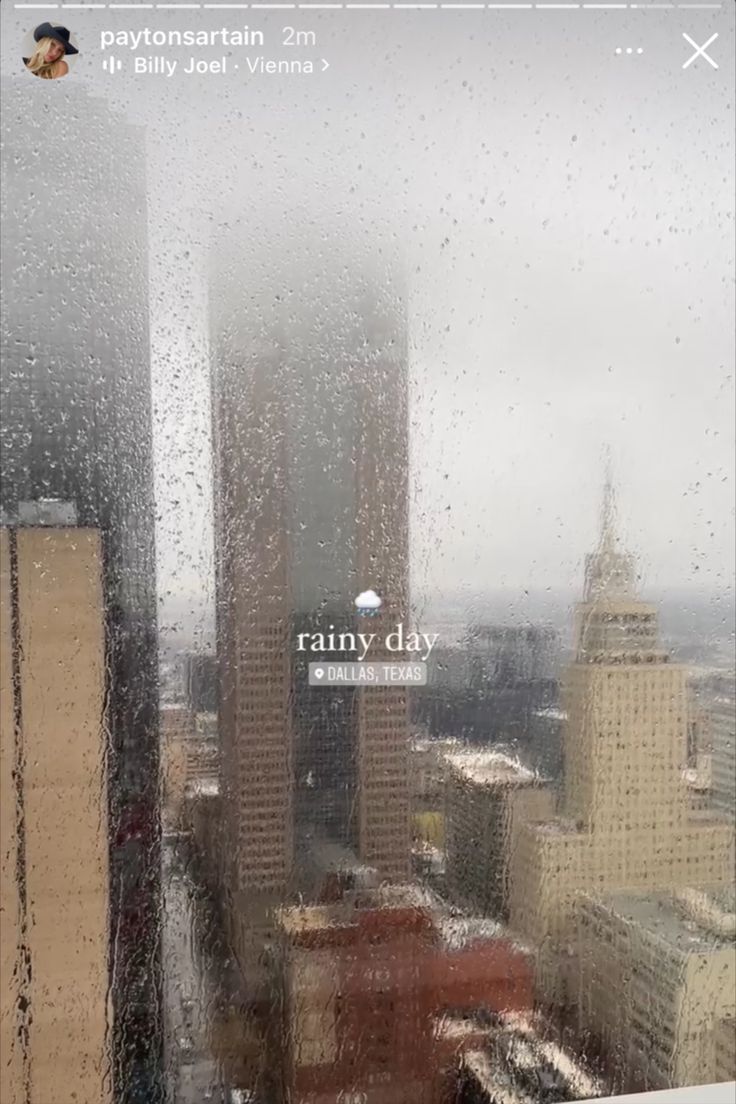 rain is falling down on the windows in this cityscape photo taken from an office building