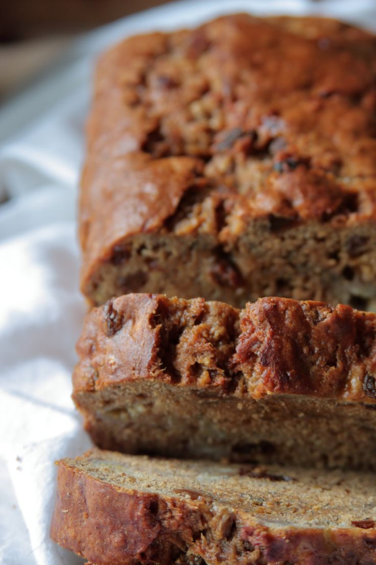 sliced loaf of banana bread sitting on top of a piece of paper