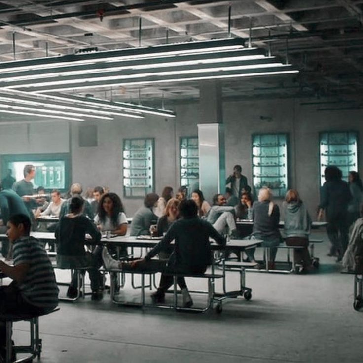 a group of people sitting around tables in a room