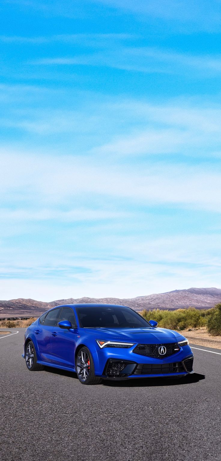 a blue car is driving down the road