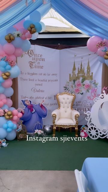 a table set up for a princess themed birthday party with balloons and streamers on the wall