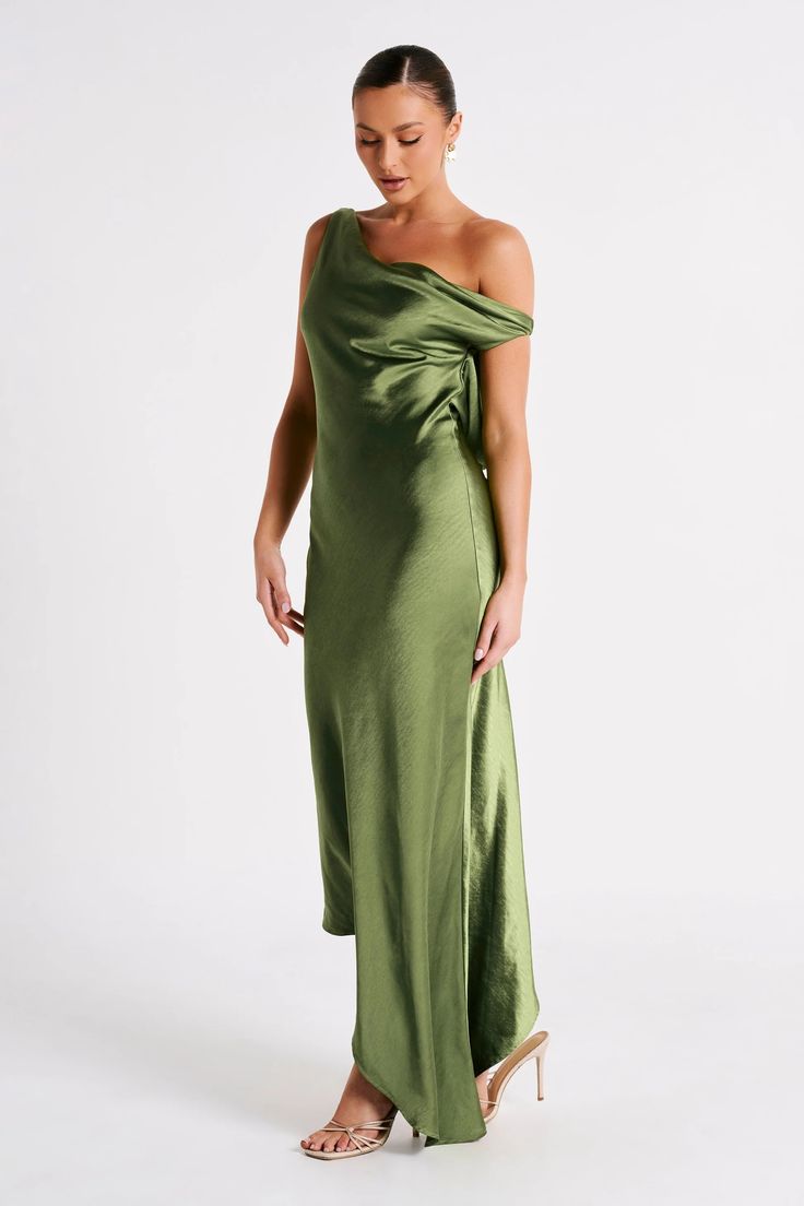 a woman in a green dress posing for the camera