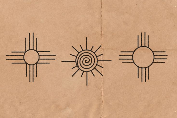 the sun and two circles are drawn on brown paper