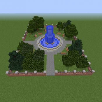 an aerial view of a blue fountain surrounded by trees