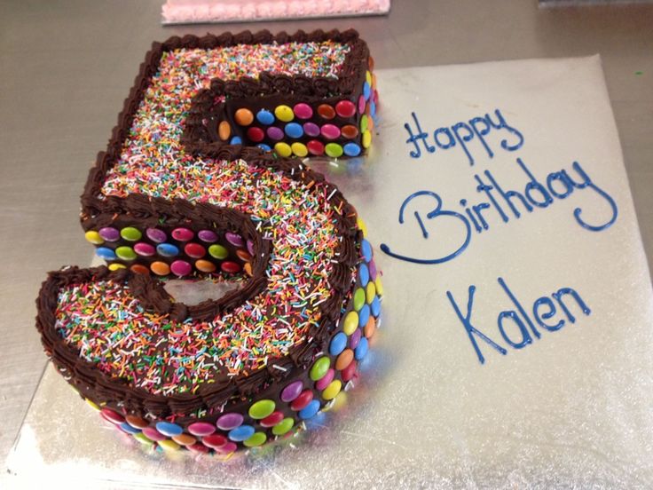 a birthday cake with the number five made out of sprinkles