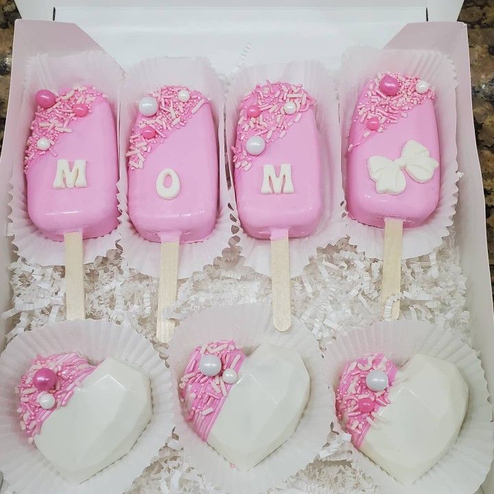 pink and white cake pops in a box