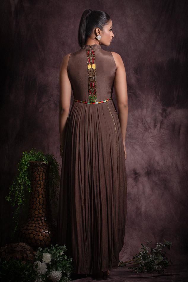 Brown in cut sleeves floor length flared gown embellished with multicolor sequin, bead work and thread embroidery on waist and cowl hem on one side.
Components: 1
Pattern: Embroidery
Type Of Work: Sequin, Beads
Neckline: Pleated collar
Sleeve Type: In cut sleeves
Fabric: Chinon, Lining: Cotton
Color: Brown
Other Details: 

Attached inner lining
Geometric and floral sequin embellishments
Length:
Gown(in inches): 59
Occasion: Cocktail, Reception - Aza Fashions Designer Wear Hand Embellished Maxi Gown, Designer Hand Embellished Maxi Gown, Designer Hand-embellished Maxi Gown, Hand Embellished Maxi Gown For Designer Wear, Designer Embroidered Floor-length Maxi Dress, Hand Embellished Georgette Maxi Gown, Anarkali Floor-length Dress With Embroidered Neckline, Designer Anarkali Maxi Dress Embellished, Multicolor Resham Embroidered Maxi Gown