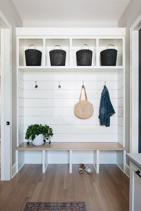 the entryway is clean and ready to be used as a storage area for shoes