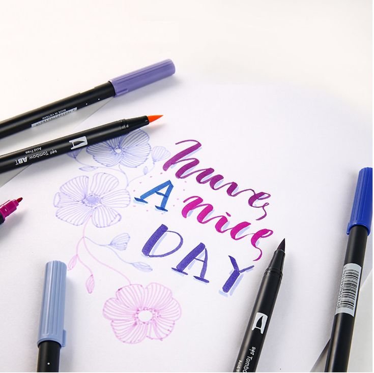 some markers and pens are laying on top of a piece of paper that says make a nice day