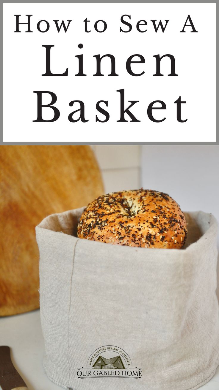 a bagel sitting on top of a white counter next to a knife and fork