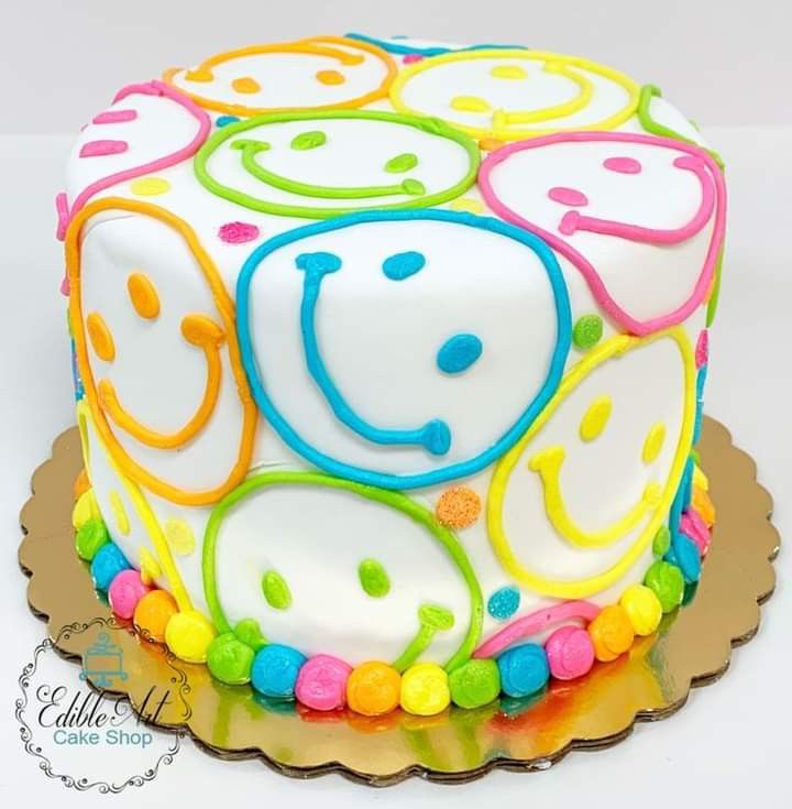 a colorful cake with smiley faces on it