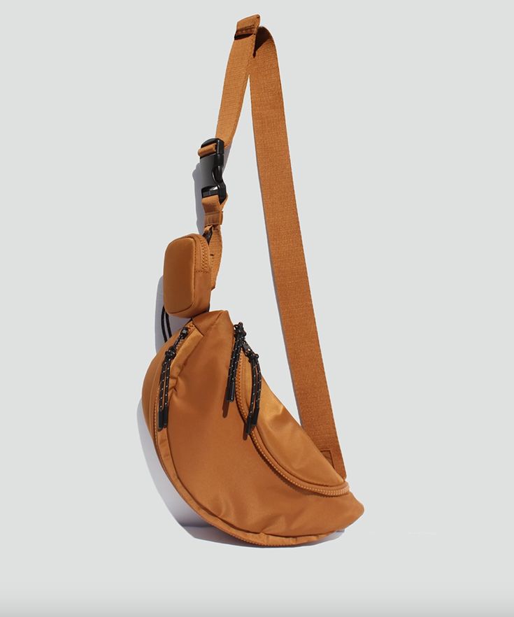 The perfect essentials sling bag. The aurelia features an adjustable strap with a buckle, a detachable mini pouch for your airpods, an interior pocket that zips closed and a nylong construction. Street Level Handbags Sling/Belt bag Dimensions: 11" x 3" x 5.5" Mother Mother, Mini Pouch, Mini Pouches, Sling Bag, Belt Bag, Adjustable Straps, Pouch, Buckle, Handbags