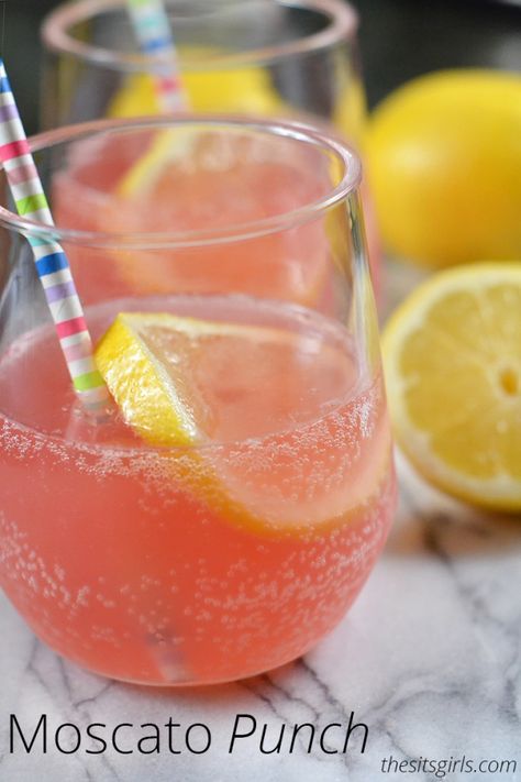 two glasses filled with pink lemonade and one has a straw sticking out of it