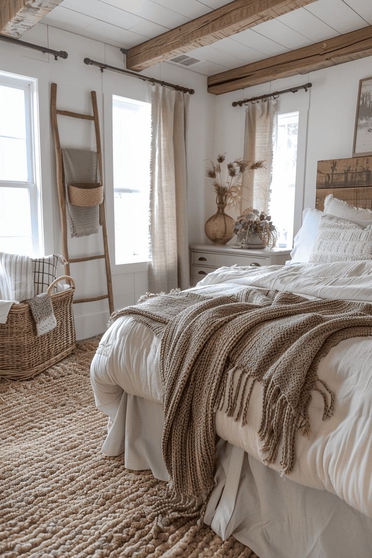 a large bed sitting in a bedroom next to two windows and a rug on the floor