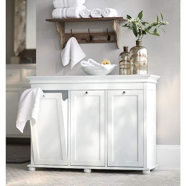 a bathroom with white cabinets and towels on the shelf