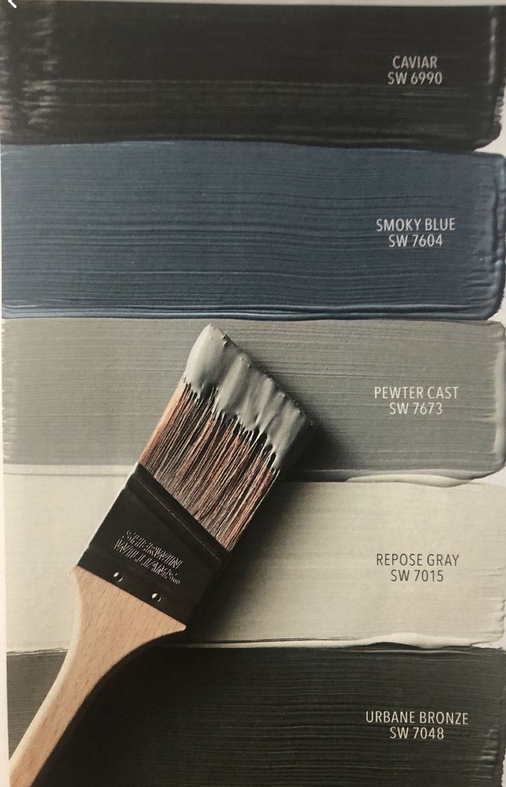 a paintbrush with different shades of gray and blue on it's side next to the same color swatches